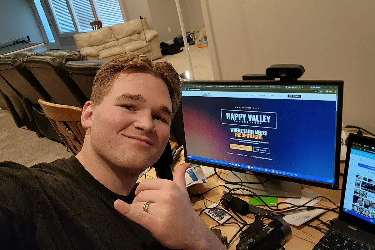 Corwin giving a thumbs up at his desk with the Happy Valley Productions site on screen