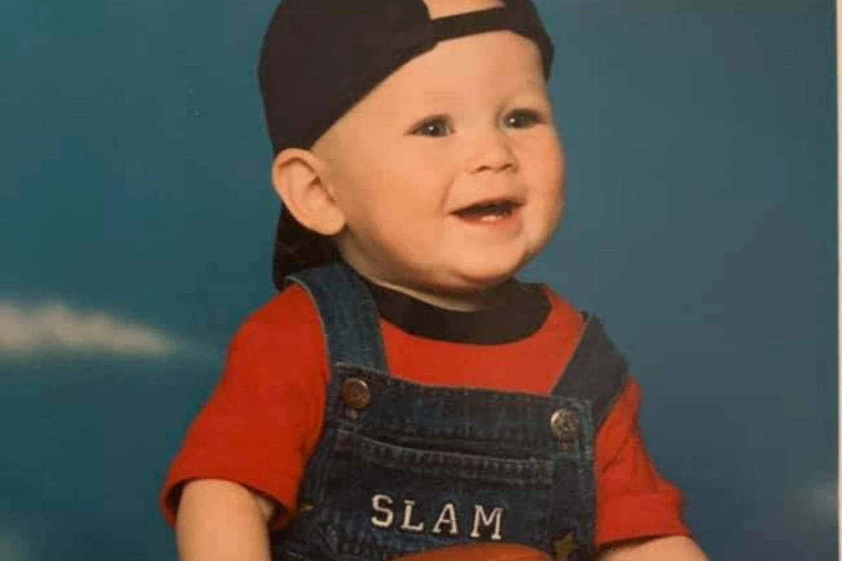 Baby Corwin in a backwards cap and SLAM overalls